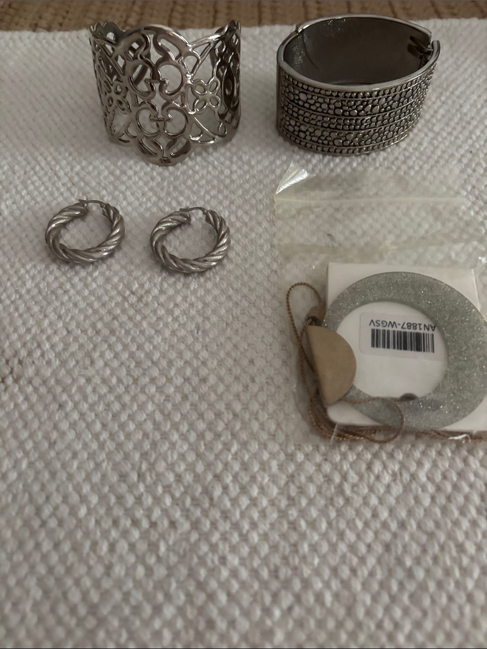 Cuff bracelets, silver braided earrings, round pendant necklace